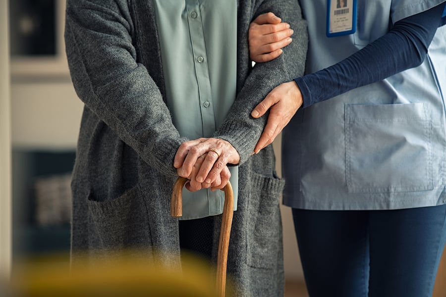 bigstock-Close-up-hands-of-caregiver-do-404596904